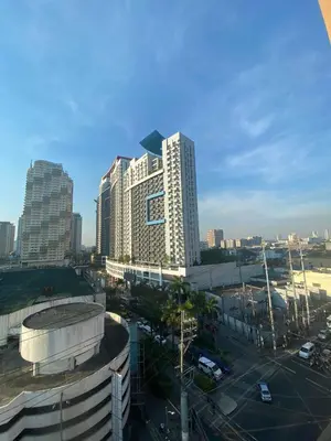 a city skyline with tall buildings and a parking lot at Fernandina 88 Suites Condo in Manila