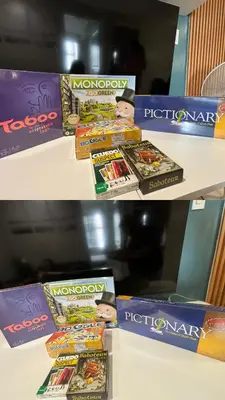 a shelf with a pile of monopoly board games at 153 Urban Escape in Manila