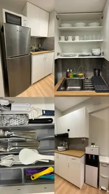 a kitchen with white cabinets and a stainless steel refrigerator at 153 Urban Escape in Manila
