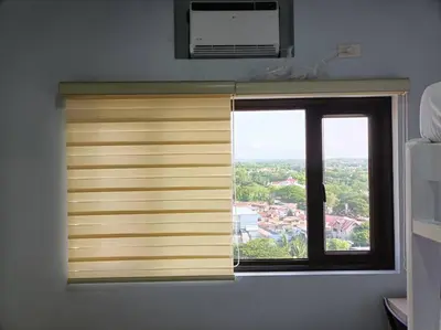 a window with a wooden blind in a room at Lorde's Hideaway in Manila