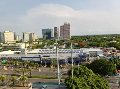 a city with a building and a parking lot at Lorde's Hideaway in Manila