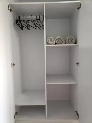 a white walk in closet with white shelves at Lorde's Hideaway in Manila