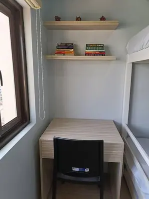 a small desk with a chair in a room at Lorde's Hideaway in Manila