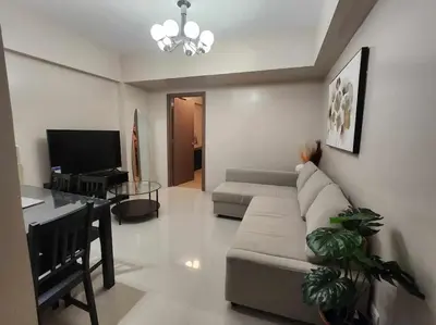 a living room with a couch and a table at Newport City Family Suite near NAIA T3 in Manila