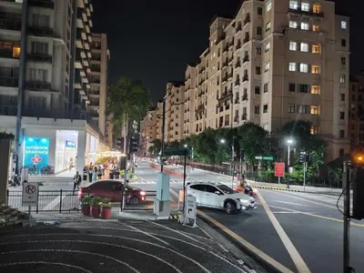 a city street at night with cars and buildings at Newport City Family Suite near NAIA T3 in Manila