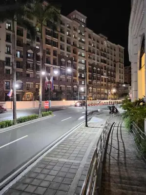 a city street at night with buildings and street lights at Newport City Family Suite near NAIA T3 in Manila