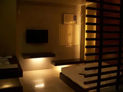 a living room with a microwave and a refrigerator at One Serenata Hotel General Trias in Rosario