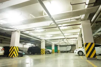 a parking garage with cars parked in it at Vista Hotel Cubao in Manila