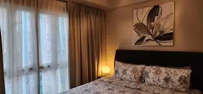 a bedroom with a bed and a large window at 1 Bed Apartment - Sleeps 7 - Pool & Wifi in Manila