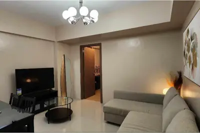 a living room with a couch and a television at 1 Bed Apartment - Sleeps 7 - Pool & Wifi in Manila