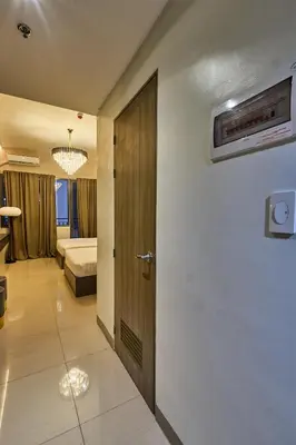 a bathroom with a door leading to a bedroom at Cozy Deluxe Double Twin Beds-MOA Pasay Shore 2-T1 in Manila