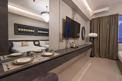 a room with a bed and a table with plates on it at Cozy Deluxe Double Twin Beds-MOA Pasay Shore 2-T1 in Manila