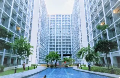a pool in the middle of a city with tall buildings at Cozy Deluxe Double Twin Beds-MOA Pasay Shore 2-T1 in Manila