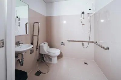 a bathroom with a toilet and a sink at The City Flats Circuit in Manila
