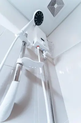 a white shower in a white room with a shower at The City Flats Circuit in Manila