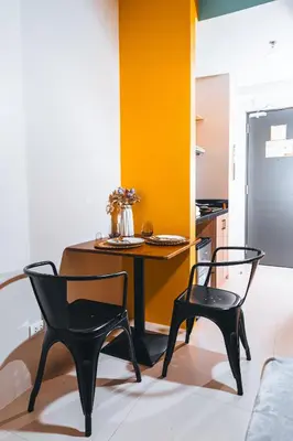 a dining room with a table and two chairs at The City Flats Circuit in Manila