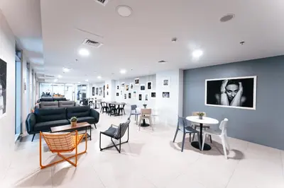 a living room with a couch and tables and chairs at The City Flats Circuit in Manila