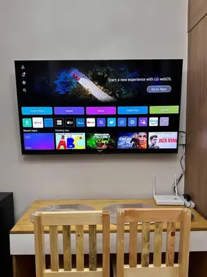 a flat screen tv hanging on a wall at Cozy Condo in Taguig in Manila