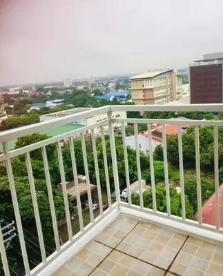 a white balcony with a view of a city at Lovely two bedroom apartment with balconies in Manila