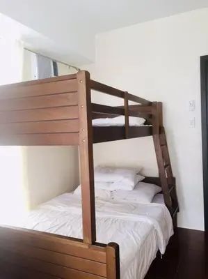 a couple of bunk beds in a room at Lovely two bedroom apartment with balconies in Manila