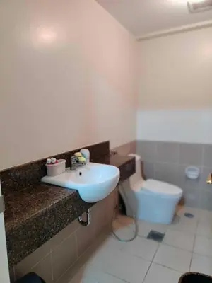a bathroom with a sink and a toilet at Satori Residence in Manila