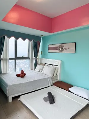 two beds with teddy bears on them in a bedroom at Elegant 4BR with balcony and bathtub in Uptown BGC in Manila