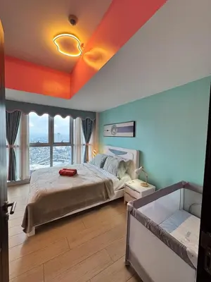 a bedroom with a bed with an orange ceiling at Elegant 4BR with balcony and bathtub in Uptown BGC in Manila