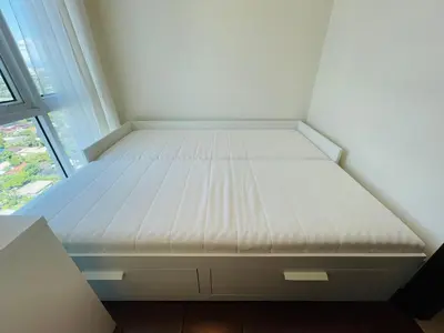 a bed in a small room with a window at Hayahay Vacay in Manila