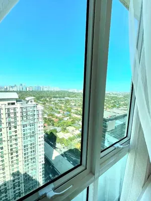 an open window with a view of a city at Hayahay Vacay in Manila