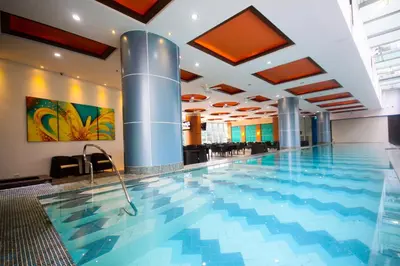 a large swimming pool in a hotel lobby at UPad Hotel in Manila