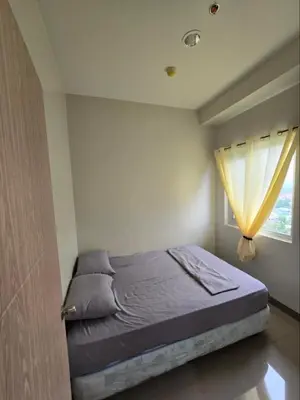 a bed in a bedroom with a window at Apartment Condo Unit in Rizal in Manila