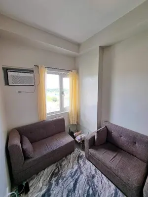 a living room with a couch and a window at Apartment Condo Unit in Rizal in Manila