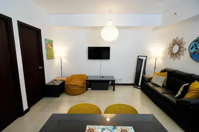 a living room with a couch and a table at Hayahay Rentals in Manila