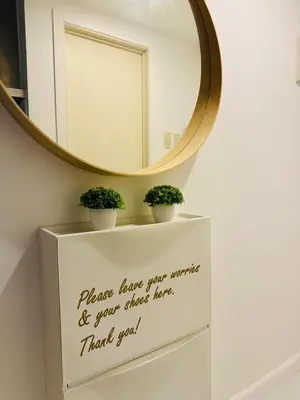 a mirror on top of a dresser with two plants at Masies Beach View Suite at Azure Urban Resort Residences in Manila