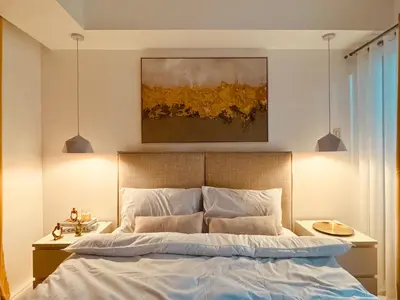 a bedroom with a bed and a painting on the wall at Masies Beach View Suite at Azure Urban Resort Residences in Manila
