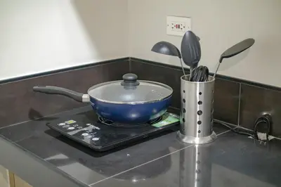 a blue pot sitting on top of a stove at Quiet Oasis in Bloom Residences in Manila