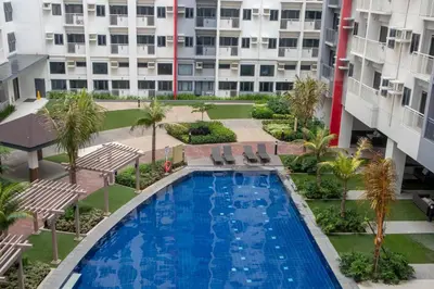 an overhead view of a swimming pool in a building at Quiet Oasis in Bloom Residences in Manila