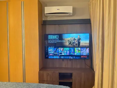 a flat screen tv on a wall in a bedroom at One Uptown Residences BGC in Manila