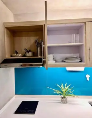 a kitchen with a counter with a laptop in it at Cozy Spacious Pet Friendly Unit with Netflix Pool Gym in Manila