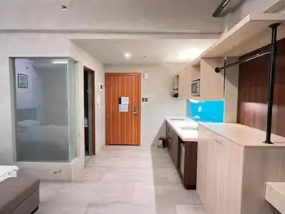 a large kitchen with a glass door in a room at Cozy Spacious Pet Friendly Unit with Netflix Pool Gym in Manila