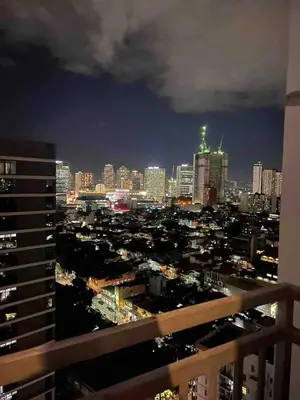 a view of a city skyline at night at Cozy Spacious Pet Friendly Unit with Netflix Pool Gym in Manila