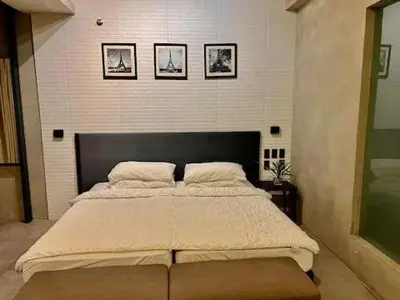 a bedroom with a large bed with three pictures on the wall at Cozy Spacious Pet Friendly Unit with Netflix Pool Gym in Manila
