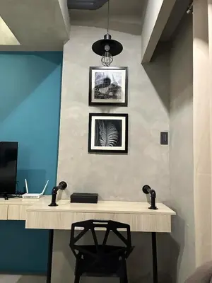 a desk in a room with a computer on a wall at Cozy Spacious Pet Friendly Unit with Netflix Pool Gym in Manila