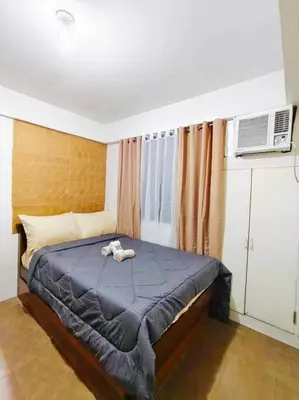 a bedroom with a bed with a stuffed animal on it at Belthena Suite in Las Piñas Near Airport in Manila