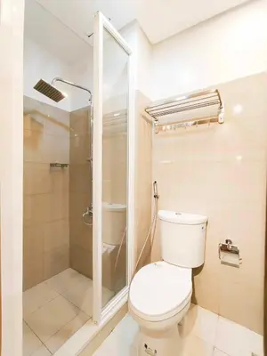 a bathroom with a toilet and a shower at Premium Condotel Close To MOA in Manila