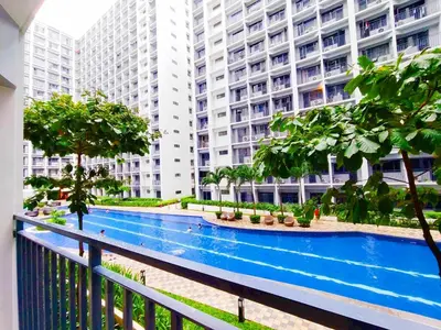a large apartment building with a large swimming pool at Premium Condotel Close To MOA in Manila