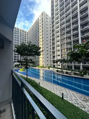 a view of a pool in a city with tall buildings at Premium Condotel Close To MOA in Manila