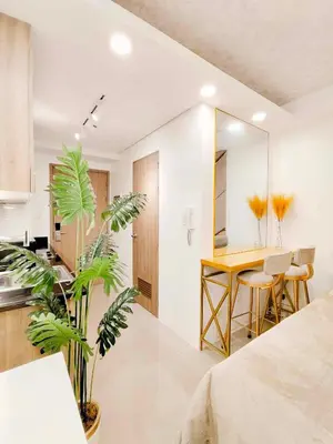 a kitchen and dining room with a table and plants at Premium Condotel Close To MOA in Manila