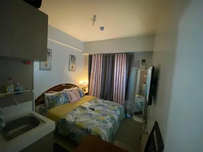 a small bedroom with a bed and a sink at Pierrecondotel in Manila