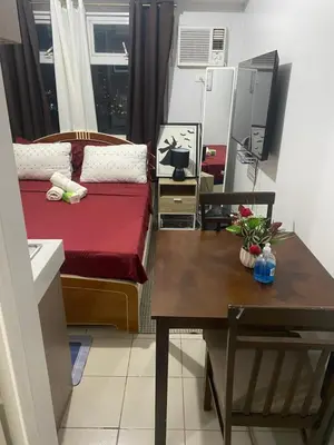a small room with a bed and a table at Pierrecondotel in Manila